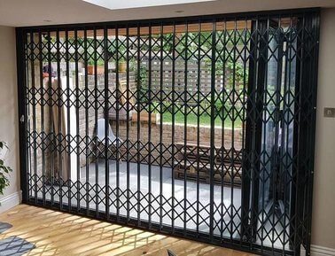 Collapsible security bars for sliding doors - locked