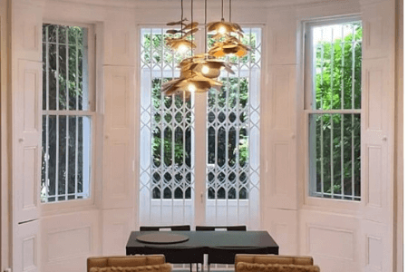 Fixed security bars and retractable security grilles